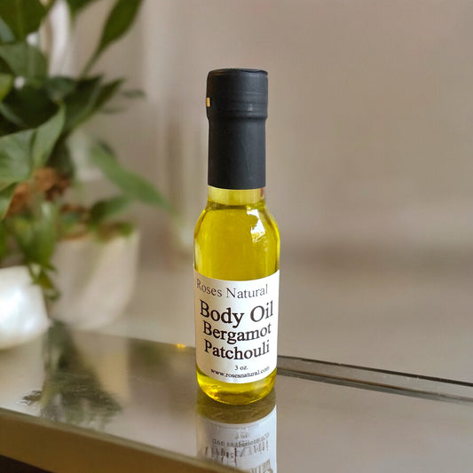 A bottle of Patchouli Essential Oil from Roses Natural placed on a clean table.