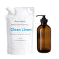 White refill pouch and brown bottle of 'Clean Linen' liquid hand soap by Roses Natural on a white background.