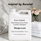 Jug of Roses Natural Plant-Based Active Wear Laundry Detergent on a marble surface with flowers in the background. Rouge Luxe scent 