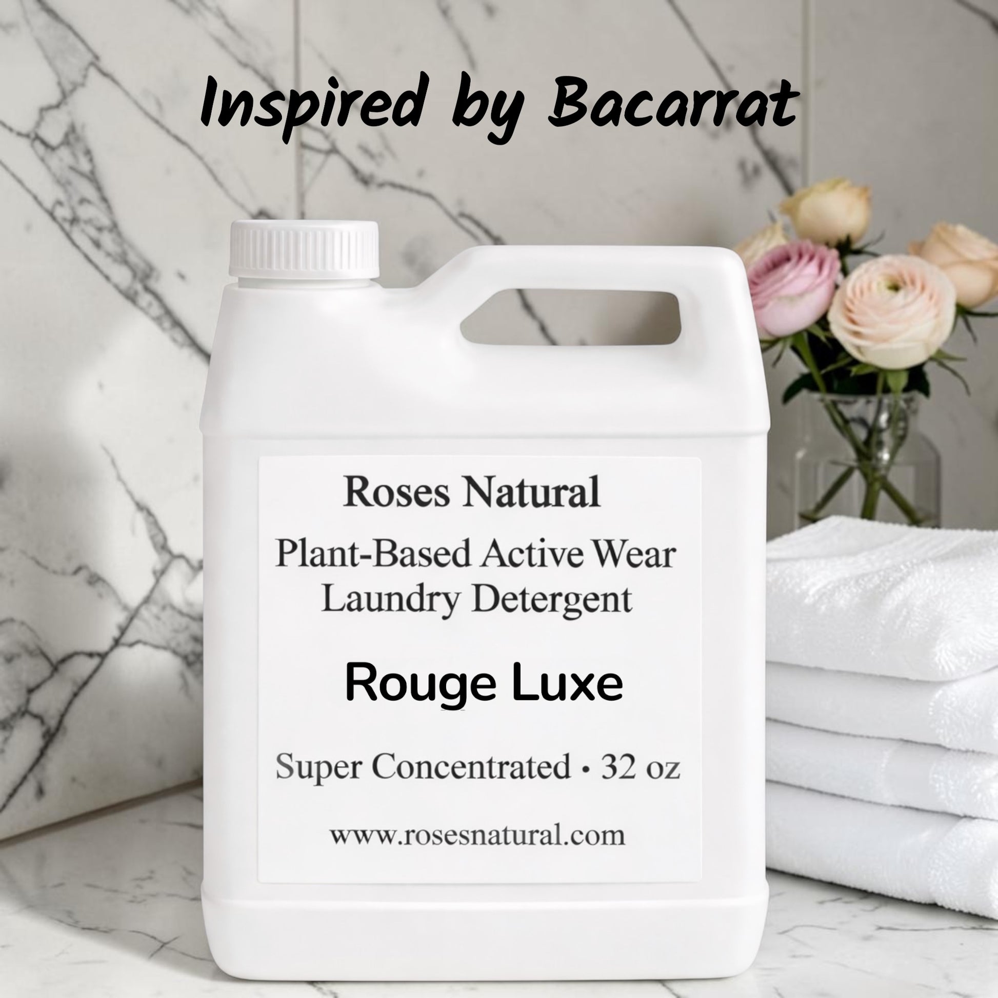 Jug of Roses Natural Plant-Based Active Wear Laundry Detergent on a marble surface with flowers in the background. Rouge Luxe scent 