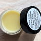Oma Baby Organic Diaper Rash Balm jar on a light wooden surface