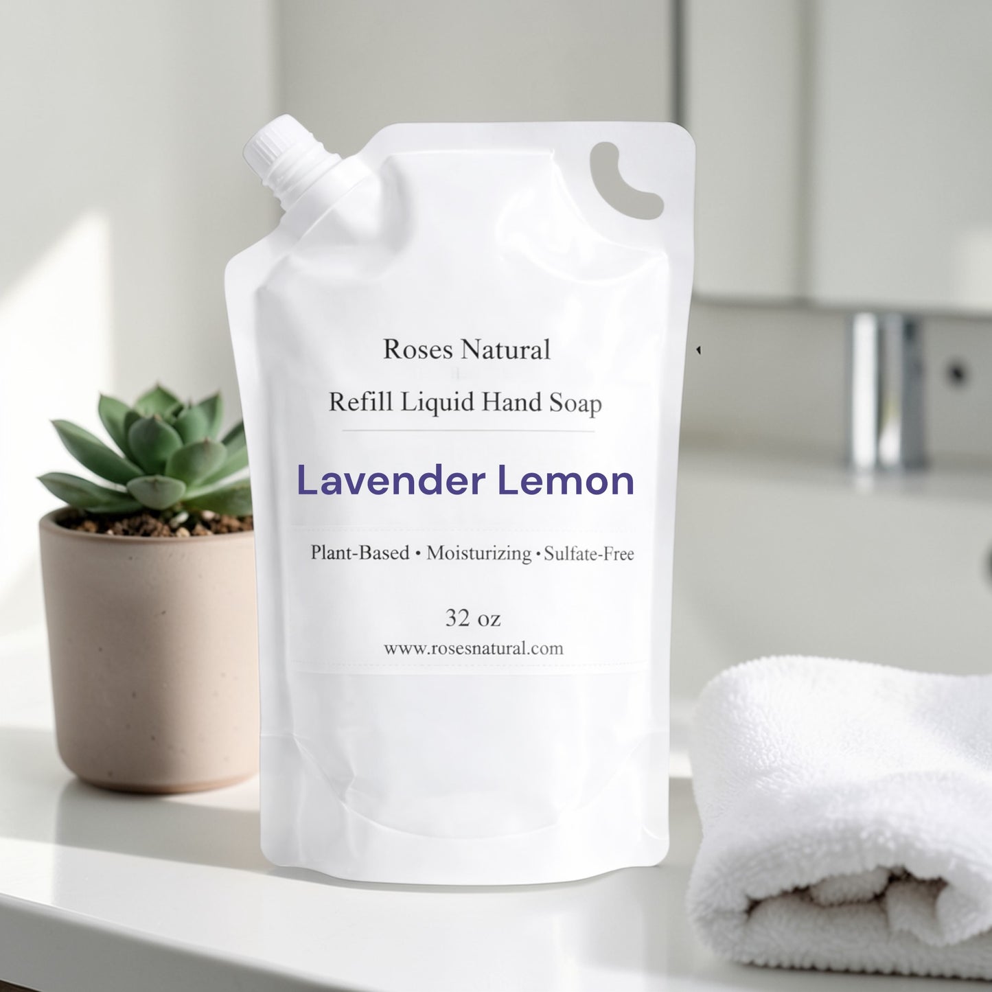 Refill liquid hand soap package labeled 'Roses Natural' on a bathroom counter with a plant and towel in the background. Lavender Lemon