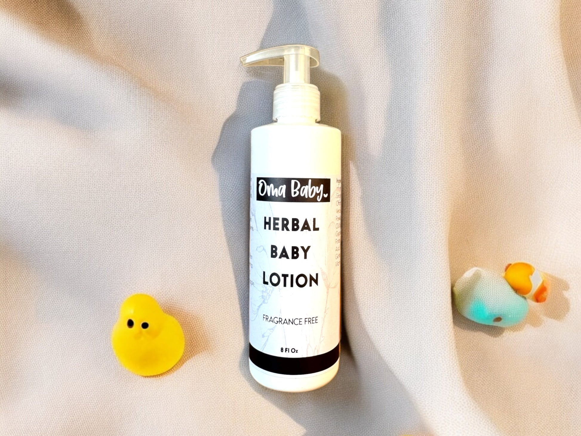 Baby lotion bottle labeled 'Ovia Baby' on a soft fabric background with rubber duckies.