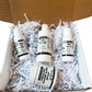 Four bottles of organic baby products in a box with white crinkle paper